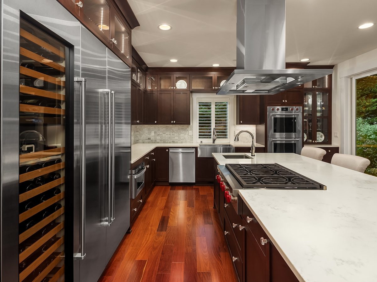 Chef's kitchen with large island, cherry cabinetry, Wolf double ovens and six-burner cooktop, and Subzero towers